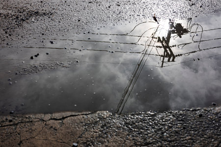 Rain Puddles On Concrete Ground, symbolizing reflection, calm, and renewal, perfect for mood...