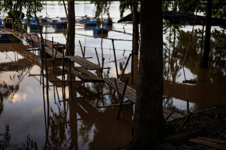 Rising Water In Rainy Flood Season, A dramatic photo of rising water in rainy flood season, waves crashing under stormy sky, perfect for a disaster awareness campaign or climate documentary.の写真素材