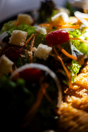 A crispy ad photo of fried chicken salad with mixed veggies, pieces a top vibrant green, perfect for healthy food or meal documentary.の写真素材