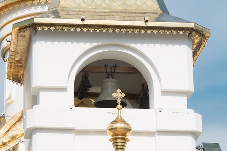 orthodox cathedral on a sunny summer day with green grass in front of it and the blue cloudy sky on the backgroundの写真素材
