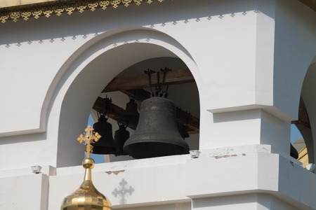 orthodox cathedral on a sunny summer day with green grass in front of it and the blue cloudy sky on the backgroundの写真素材