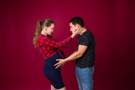 young pregnant woman and her man embracingの写真素材