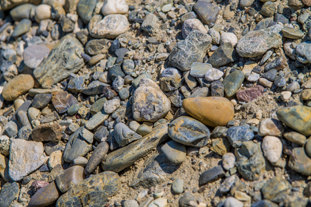 gray, brown and blue cobblestones and little stones backgroundの写真素材
