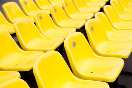 yellow plastic empty stadium seats before an event