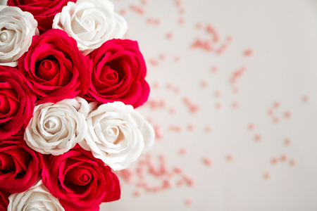 Red and White roses isolated on a white background with space for A textの写真素材