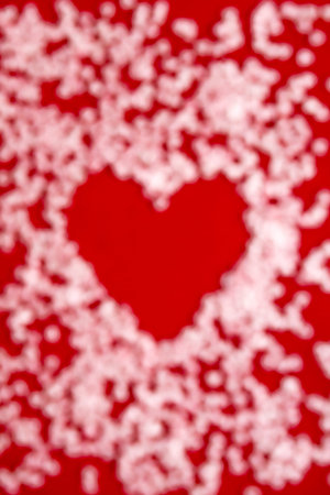 vertical banner with a blurred red heart in the centre as a background shaped with lots of blurred...