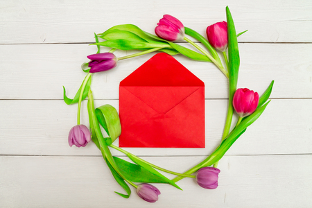 Beautiful red and pink tulips on a white background with space for text and congratulations. Top view, flat lay.の写真素材
