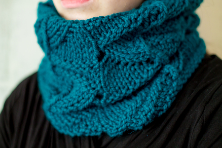 a knitted textured snood on a girl's neck close upの写真素材