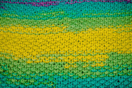 a multicolor yellow, green, orange and purple horizontal knitted pattern background