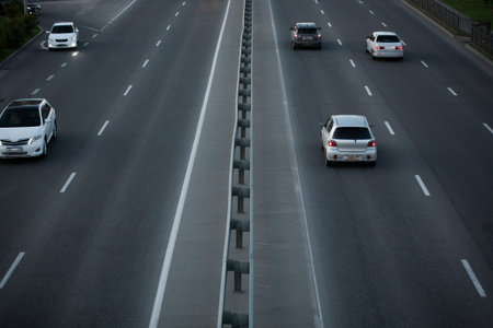 an asphalt road with marking lines and cars. view from above
