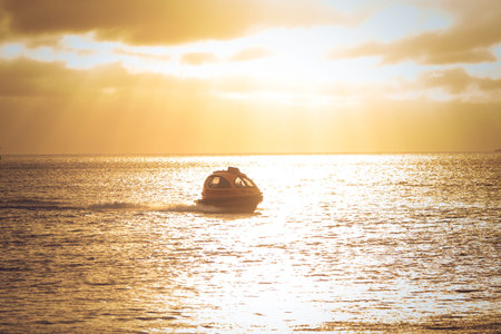 a Water Taxi capsule in the sea during the sunset
