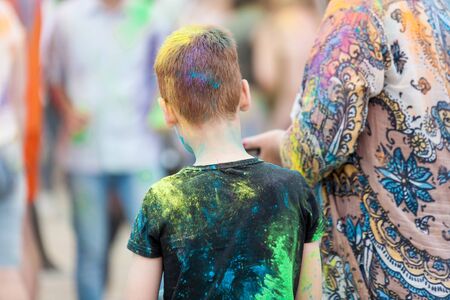 people shot from the back side with their colorful clothes stained with holi colors on Holi Festival, Festival of Colorsの写真素材