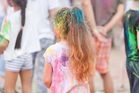 people shot from the back side with their colorful clothes stained with holi colors on Holi Festival, Festival of Colorsの写真素材