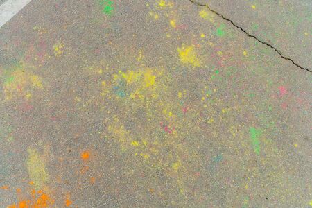 Holi colors scattered on asphalt after Holi festivalの写真素材