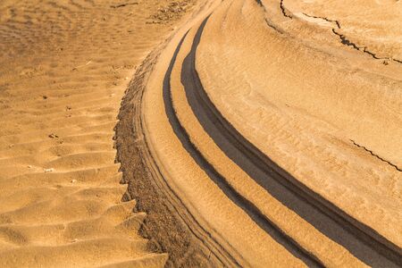 Golden sand vawe texture background on the beachの写真素材