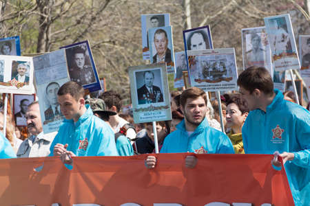 KHABAROVSK, RUSSIA - MAY 9, 2017: a March of Immortal Regiment, devoted to the Victory in the great Patriotic war. People marching after the militari parade wih their fathers and granddads photos making a big regimentのeditorial素材