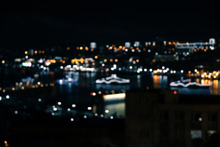Defocused blurred night city view with lights on black backgroundの写真素材