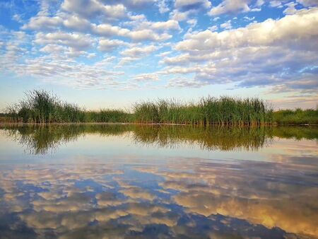 Lake against blue sky and white cloudsのeditorial素材