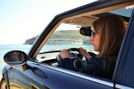 Young woman driving a vintage carの写真素材