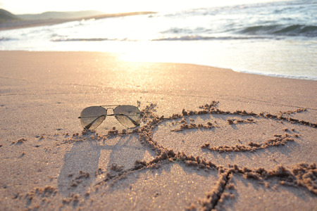 Picture of sun and waves on the sandの写真素材