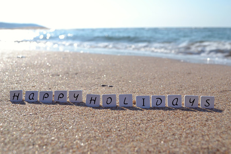 Holiday sign on the beach sand wordの写真素材
