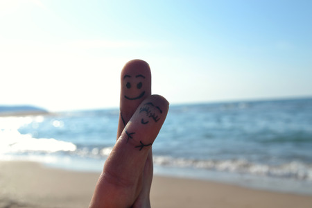 Happy couple in love with painted smiley and huggingの写真素材