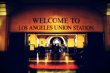 Los Angeles, USA-July 4, 2013. Passengers walking or sitting on chairs inside Union Station in Los Angeles, California. L. A. Union Station is located at 800 N. Alameda Street in Los Angeles. It is the largest railway station in the Western United States.のeditorial素材