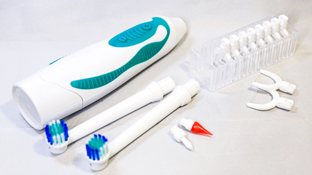Electronic toothbrush with toothbrush heads white color backgroundの写真素材