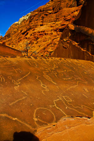 Ancient Native American Petroglyphs on Sandstone Rock in Red Rock Canyon State Park National Conservation Area.の写真素材