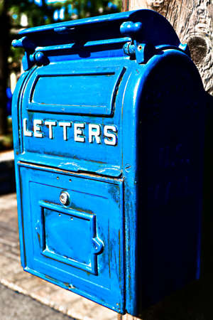 Antique Blue Letter Box on the Telegraph made of wood.Vintage metal mail box.Front view of Very Old (Vintage) big blue US Postal mail box.の写真素材