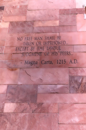 Article of Magna Carta text on of the old brick wall
