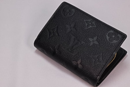 OSAKA,JAPAN - AUG 12,2023 : Louis Vuitton UNISEX Black leather wallet "Portefeuille crea" isolated on white backgroundのeditorial素材