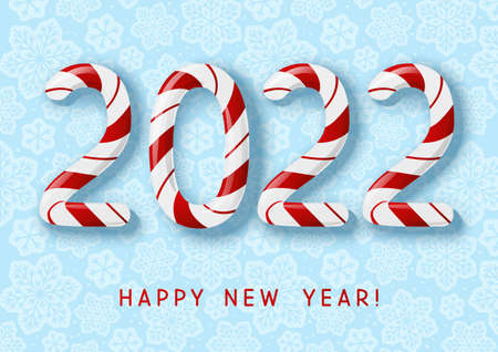 New Year concept - 2022 candy numbers on blue snowflakes background for winter holidays designの写真素材