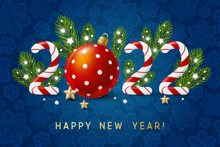 New Year concept - 2022 candy numbers with Christmas decor on blue snowflakes background for winter holidays designの写真素材