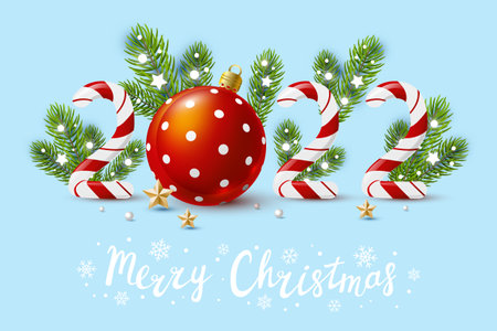 New Year concept - 2022 candy numbers with Christmas decor on blue background for winter holidays designの写真素材