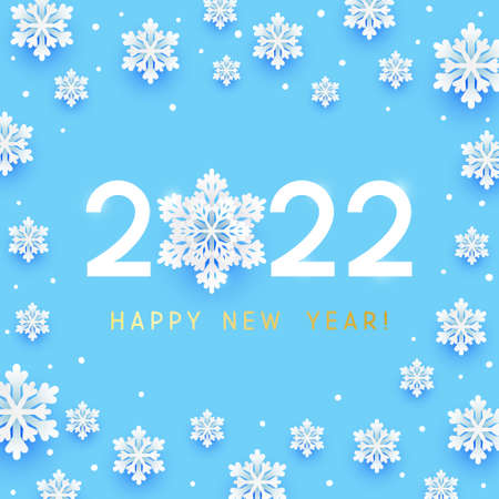 New Year concept - 2022 numbers on blue background with paper snowflakes for winter holidays designの写真素材