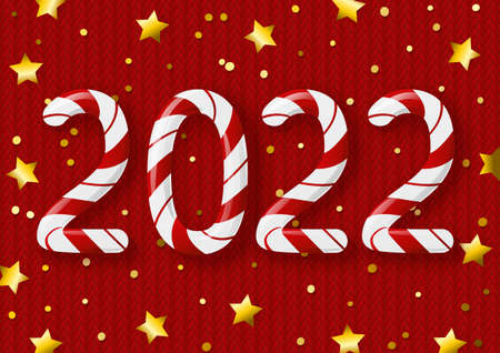 New Year concept - 2022 candy numbers on red knitted background with golden stars for winter holidays designの写真素材