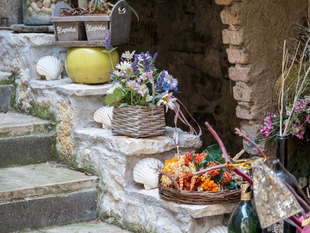 Decoration items on a stone stairway in front of a houseの写真素材
