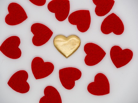 Golden heart in the middle of red heartsの写真素材