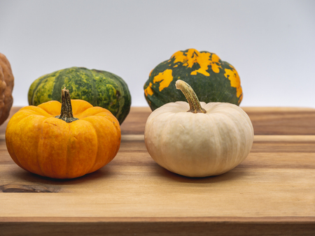 Mix of pumpkins on a wooden boardの写真素材