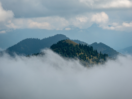 Mountains peaks in stormy and cloudy and foggy environmentの写真素材