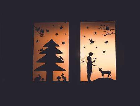 Close up image of window decoration with fairy forrest tale silhouettesの写真素材