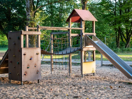 Image of wooden playgound on sandy ground during dawnの写真素材