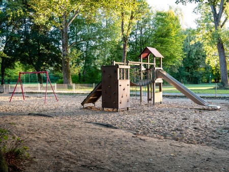 Image of wooden playgound on sandy ground during dawnの写真素材
