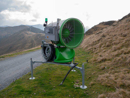 Image of snow cannon on mountain in off season without snow