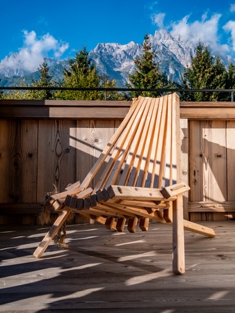 Close up image of wooden chair on balcony in alpine landscapeの写真素材