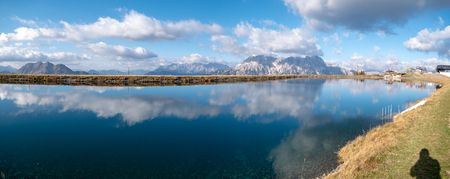 Image of mountain panorama with water reflections in lake in austriaの写真素材