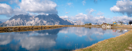 Image of mountain panorama with water reflections in lake in austriaの写真素材