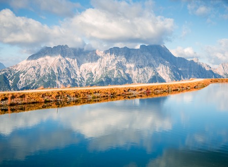 Image of mountain panorama with water reflections in lake in austriaの写真素材