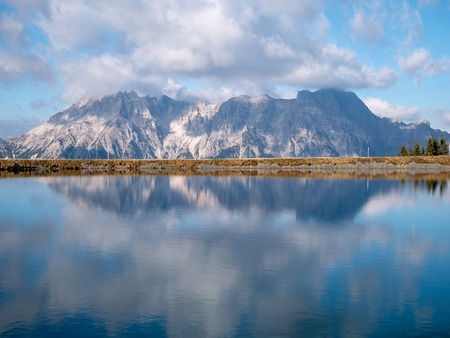 Image of mountain panorama with water reflections in lake in austriaの写真素材